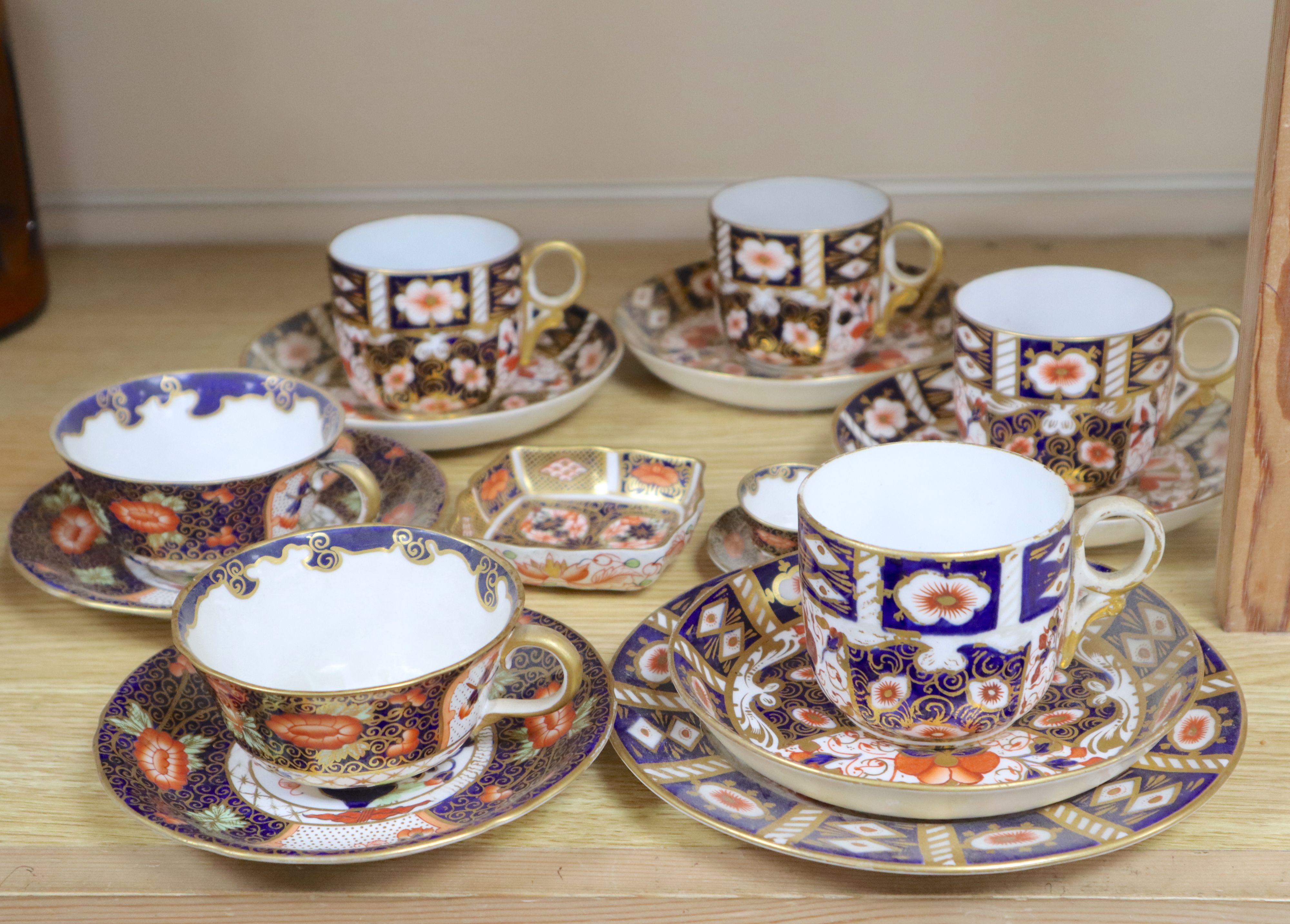 A collection of six Royal Crown Derby cups and saucers, a small square trinket dish and a miniature cup and saucer (16)
